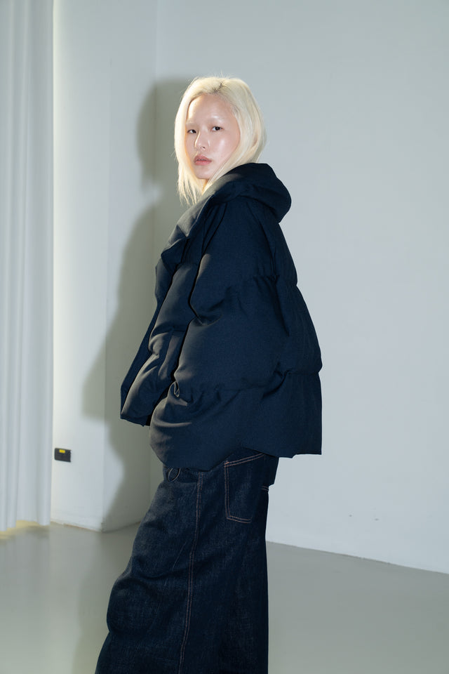 Dark blue quilted down jacket with a large lapel.